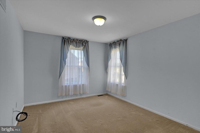 unfurnished room with light colored carpet