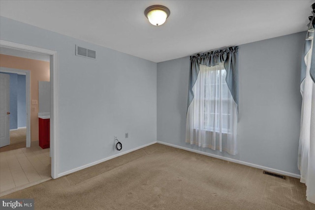 unfurnished room with light carpet