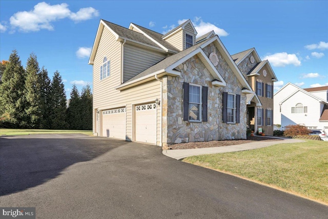 view of front of house with a garage and a front lawn