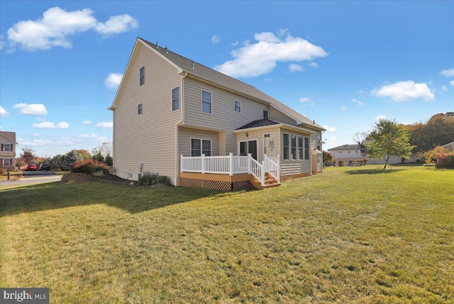 back of house with a deck and a lawn