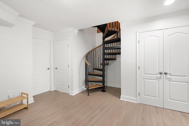 stairway featuring recessed lighting, wood finished floors, baseboards, and ornamental molding