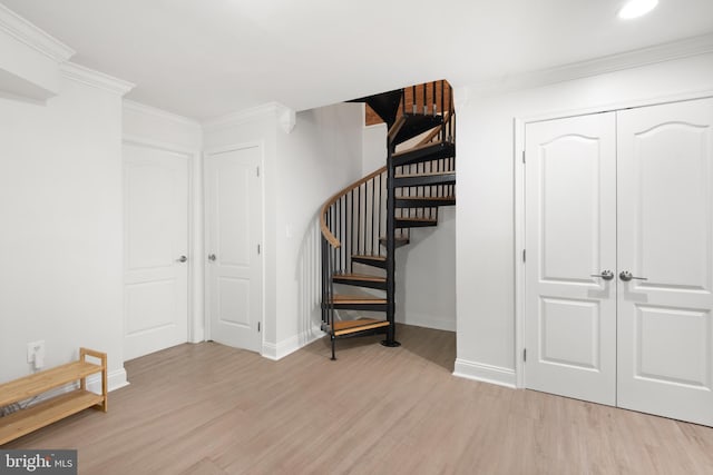 stairway with crown molding and hardwood / wood-style flooring