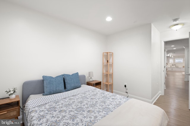 bedroom featuring recessed lighting, wood finished floors, and baseboards