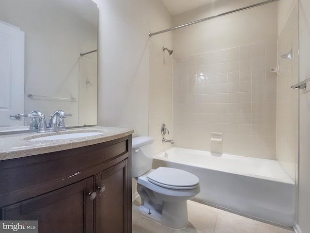 full bathroom featuring tiled shower / bath, vanity, toilet, and tile patterned flooring