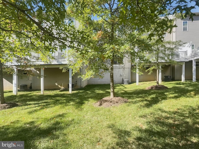 view of yard featuring a deck and central AC unit