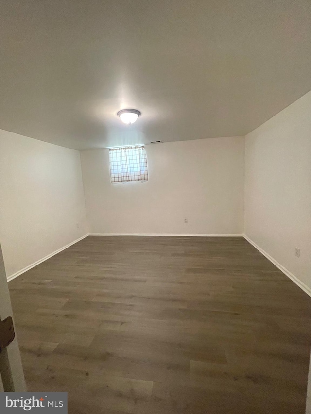 finished below grade area with dark wood finished floors and baseboards