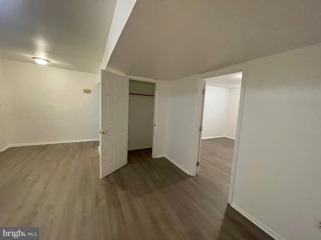 basement with dark hardwood / wood-style flooring