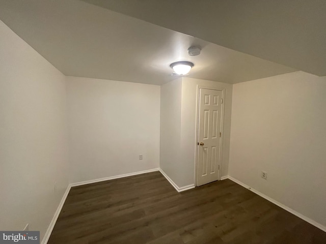 bonus room with dark hardwood / wood-style floors