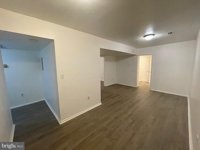 basement with dark hardwood / wood-style floors