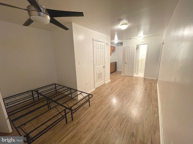 interior space with light wood-type flooring and ceiling fan