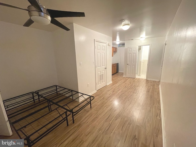 unfurnished room with ceiling fan, baseboards, and wood finished floors