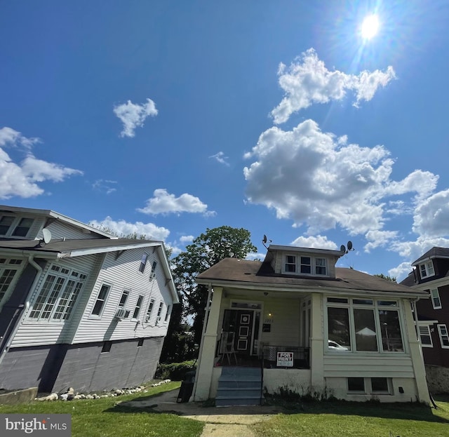 view of front of property with a front yard and covered porch