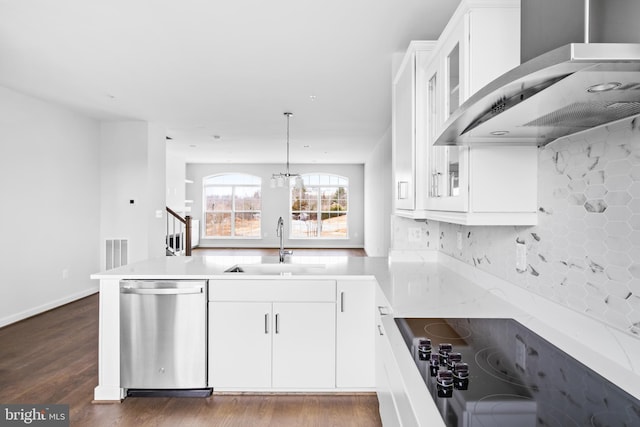 kitchen featuring dark hardwood / wood-style flooring, white cabinetry, stainless steel dishwasher, wall chimney exhaust hood, and sink