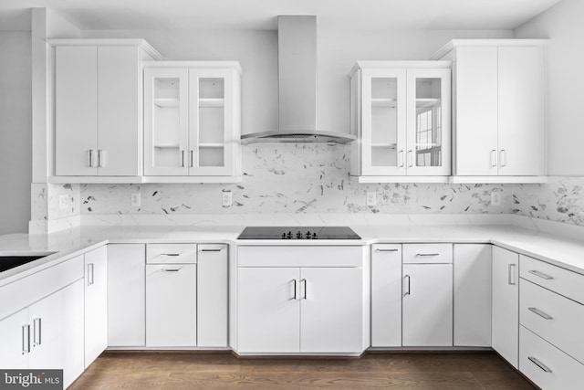 kitchen featuring black electric stovetop, white cabinetry, wall chimney range hood, and dark wood-type flooring