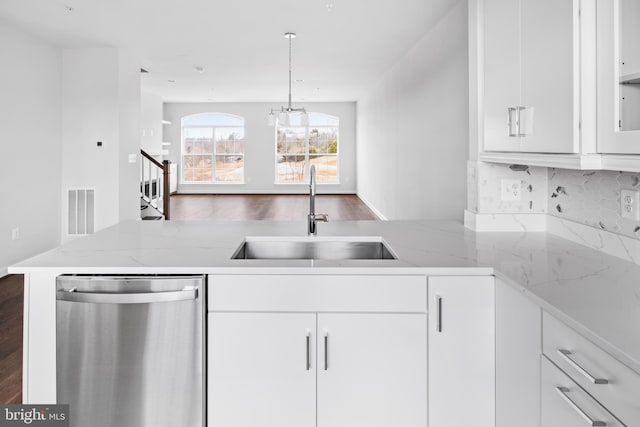 kitchen with wood-type flooring, sink, white cabinetry, pendant lighting, and stainless steel dishwasher