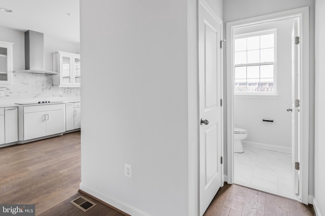 corridor with light hardwood / wood-style flooring