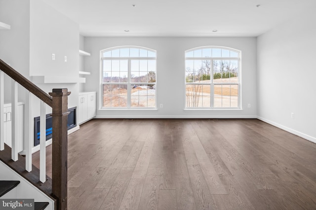 unfurnished living room with hardwood / wood-style flooring