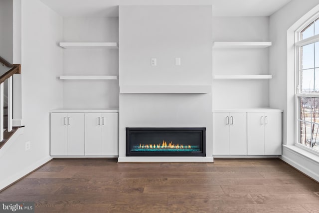 0 Triggerfish Dr, National Harbor, MD 20745 - unfurnished living room featuring a glass covered fireplace and wood finished floors