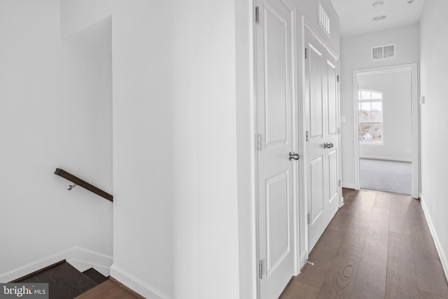 corridor featuring dark hardwood / wood-style flooring