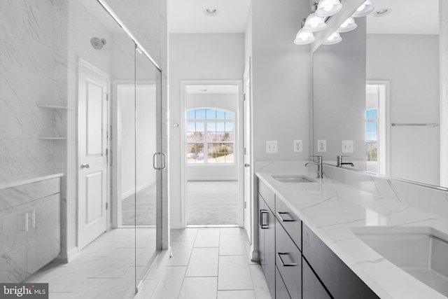 bathroom with vanity and a shower with door