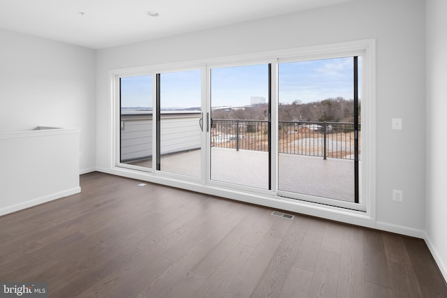 empty room with hardwood / wood-style flooring