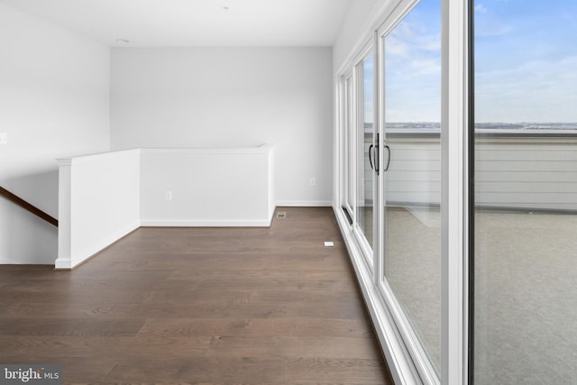 empty room with dark hardwood / wood-style flooring