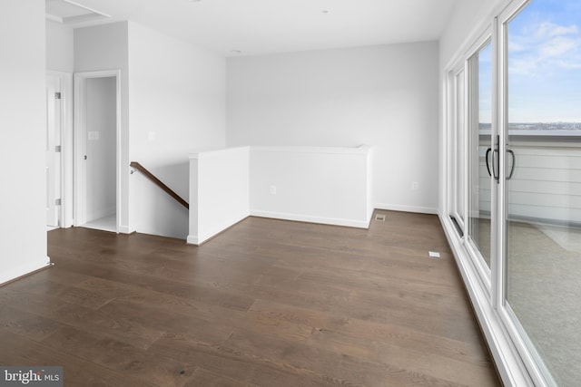 spare room featuring dark wood-type flooring