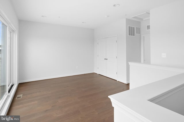 spare room with dark wood-type flooring