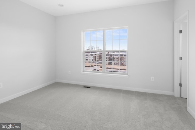 empty room featuring light colored carpet