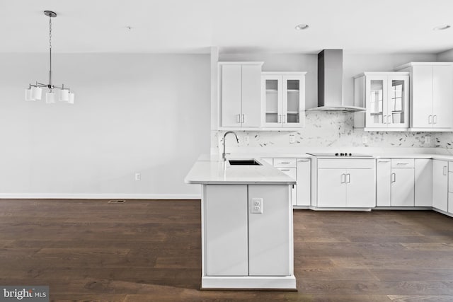 kitchen with white cabinetry, wall chimney range hood, sink, and dark hardwood / wood-style flooring