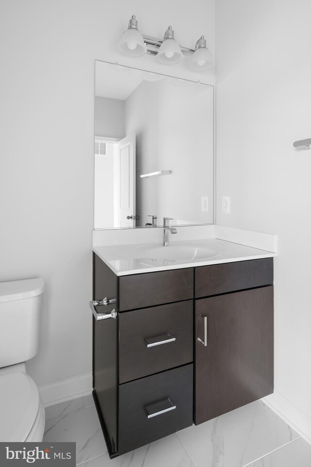 0 Triggerfish Dr, National Harbor, MD 20745 - half bathroom featuring baseboards, marble finish floor, vanity, and toilet