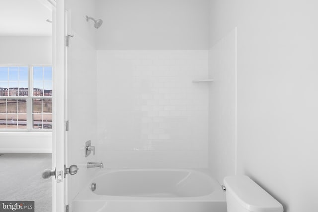 bathroom featuring toilet and bathtub / shower combination