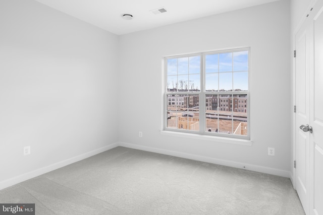 empty room with carpet flooring and plenty of natural light