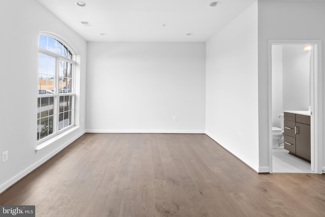 unfurnished room with light wood-type flooring