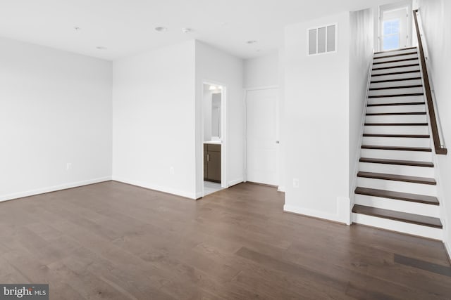 0 Triggerfish Dr, National Harbor, MD 20745 - unfurnished living room featuring baseboards, visible vents, stairs, and dark wood-style flooring