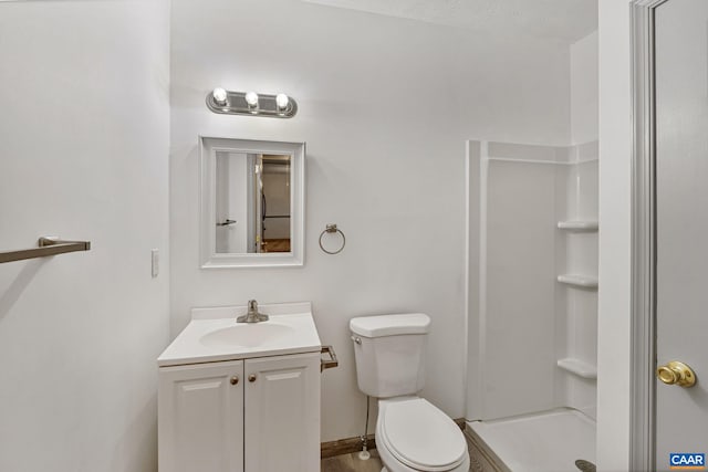 bathroom with toilet, a textured ceiling, walk in shower, and vanity