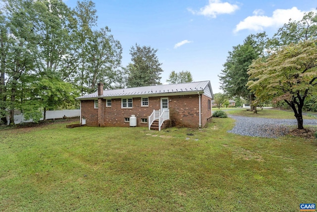 rear view of house with a yard