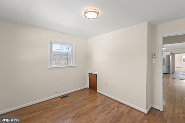 unfurnished room featuring hardwood / wood-style floors