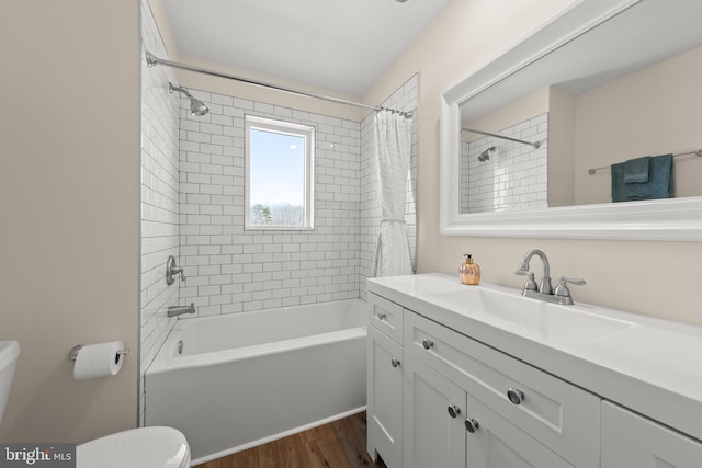 full bathroom with shower / bath combo with shower curtain, wood-type flooring, toilet, and vanity