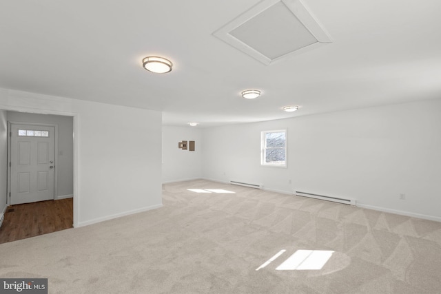 carpeted empty room featuring a baseboard radiator