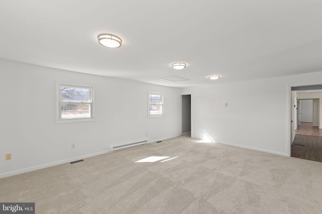 unfurnished room featuring light carpet and a baseboard heating unit