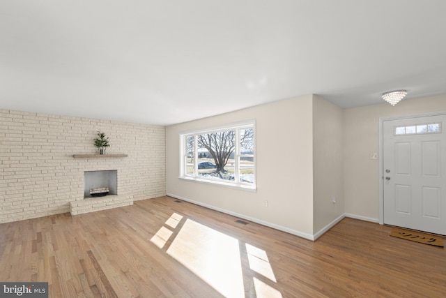 entrance foyer with a fireplace and hardwood / wood-style floors