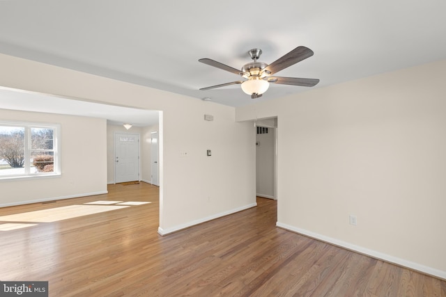 empty room featuring ceiling fan and light wood-type flooring