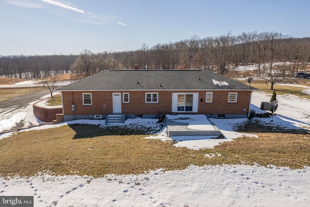 view of snow covered back of property