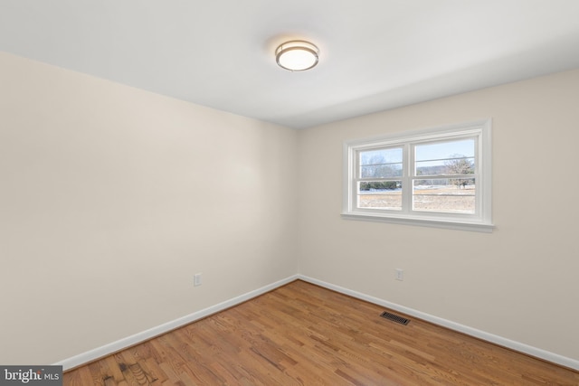 empty room with hardwood / wood-style floors