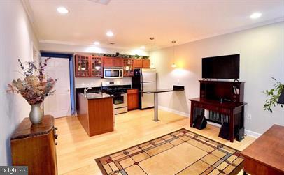 kitchen featuring kitchen peninsula, range, light hardwood / wood-style flooring, and white refrigerator