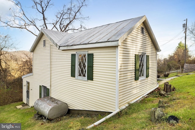 view of home's exterior featuring heating fuel and a lawn
