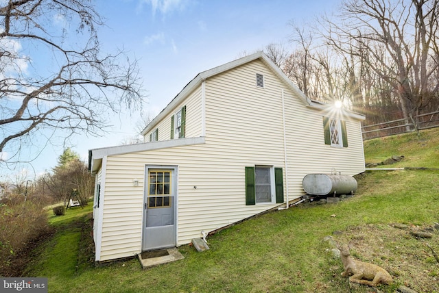 rear view of property featuring a yard