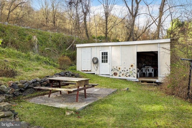 view of outbuilding with a lawn