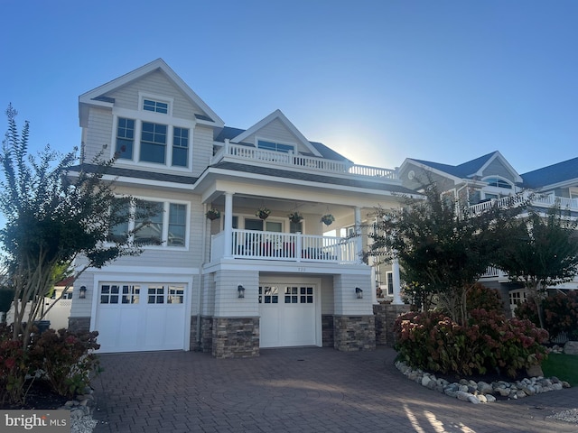 view of front facade featuring a balcony, a garage, and ceiling fan